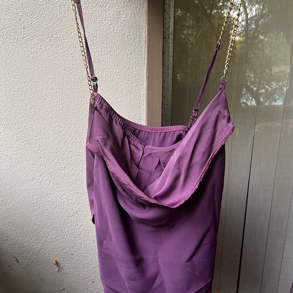 Sexy satiny asymmetrical top with gold tone chain straps!
